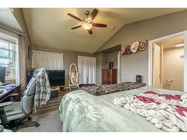 a bedroom with a bed a desk and chair