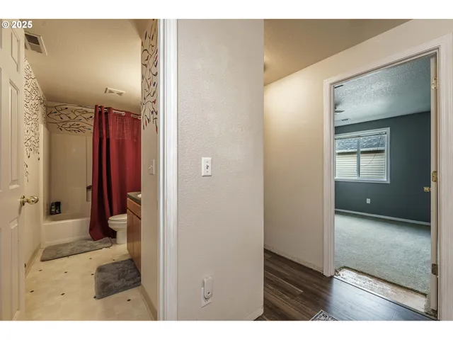 a view of a hallway with wooden shelves