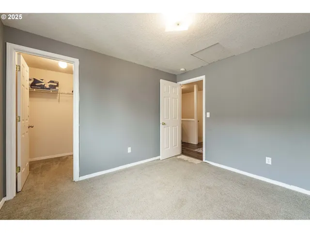 view of an empty room with closet and a window