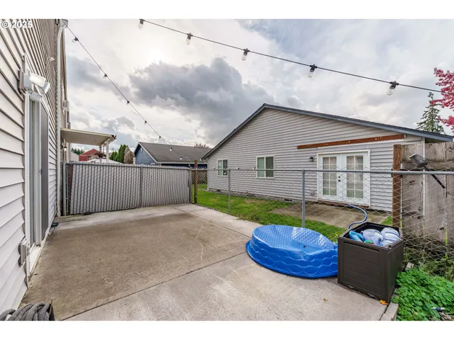 a view of backyard with outdoor seating and plants
