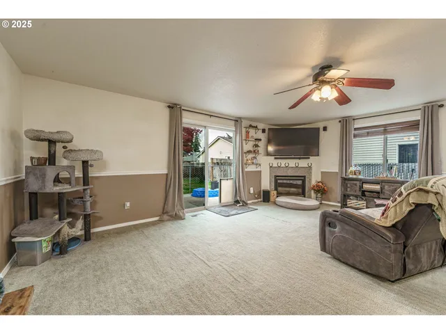 a living room with furniture a fireplace and a chandelier