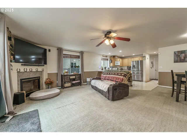 a living room with furniture a fireplace and a flat screen tv