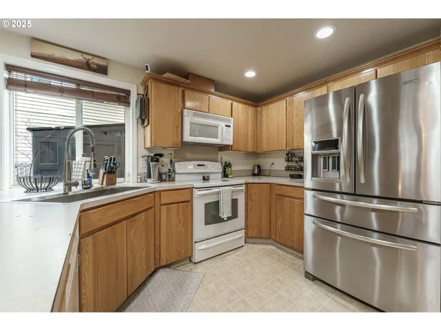 a kitchen with stainless steel appliances a refrigerator sink and cabinets