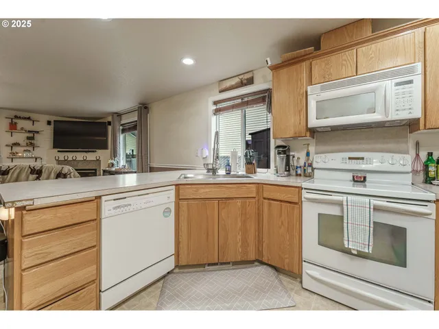 a kitchen with stainless steel appliances granite countertop a stove microwave and cabinets