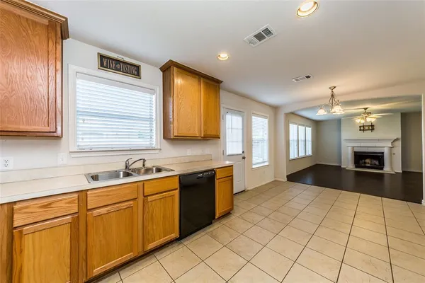 a view of a kitchen with a sink and a refrigerator