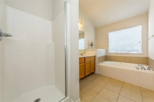 a view of bathroom with bathtub and shower