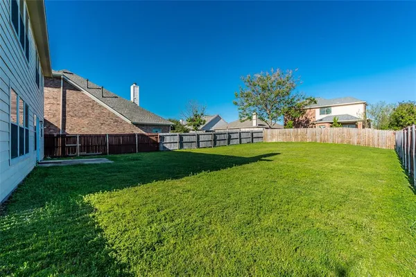 a view of house with backyard