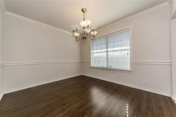 a view of a room with wooden floor and a window