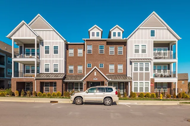 a car parked in front of a white building