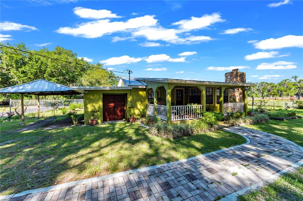 13610 Acker Road Dover, FL 33527 - Photo 1 of 53 a view of a house with a yard balcony and furniture