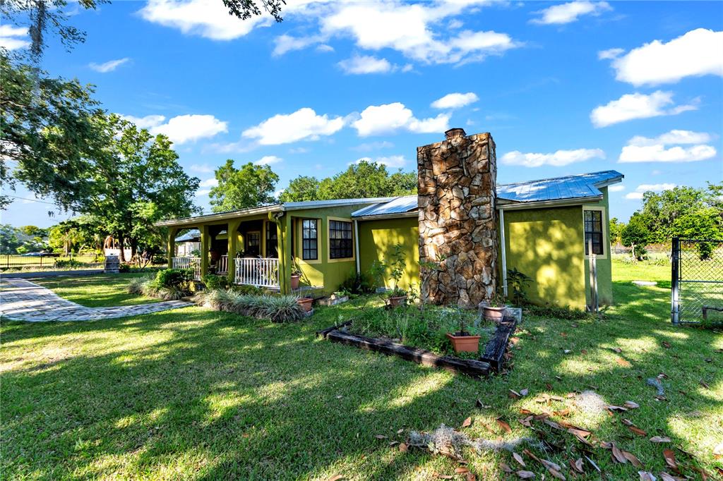 13610 Acker Road Dover, FL 33527 - Photo 2 of 53 a front view of a house with garden