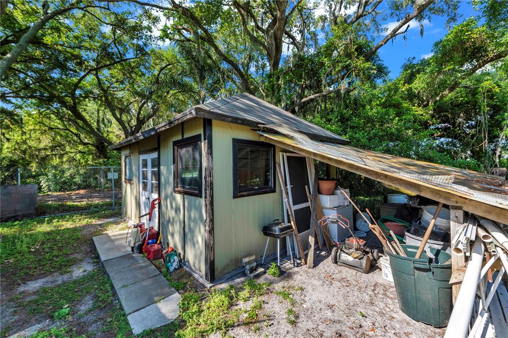 13610 Acker Road Dover, FL 33527 - Photo 27 of 53 a view of a chair and table in backyard of the house