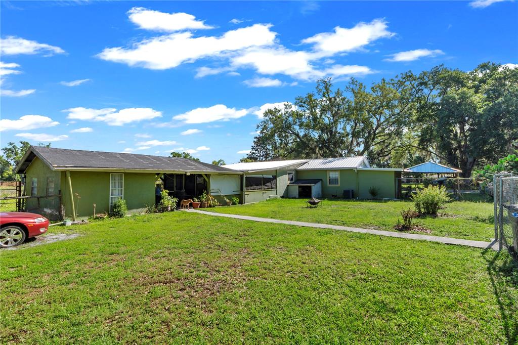 13610 Acker Road Dover, FL 33527 - Photo 30 of 53 a front view of a house with a yard and porch