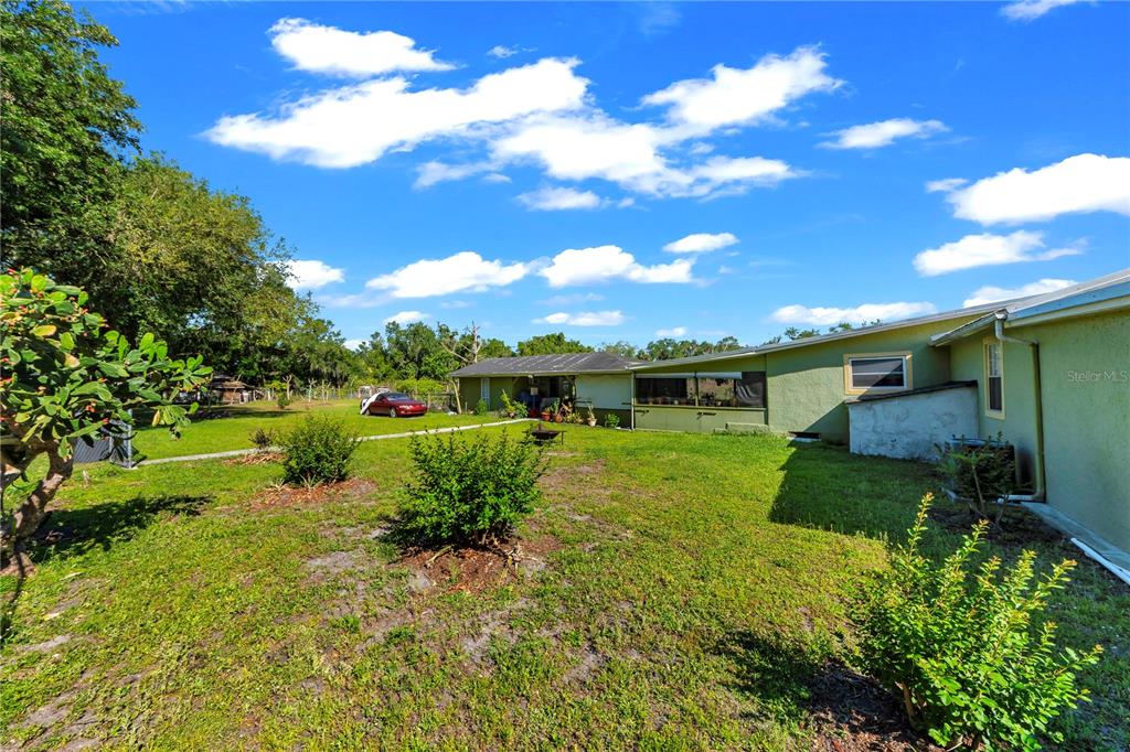 13610 Acker Road Dover, FL 33527 - Photo 31 of 53 a view of a garden with a building in the background