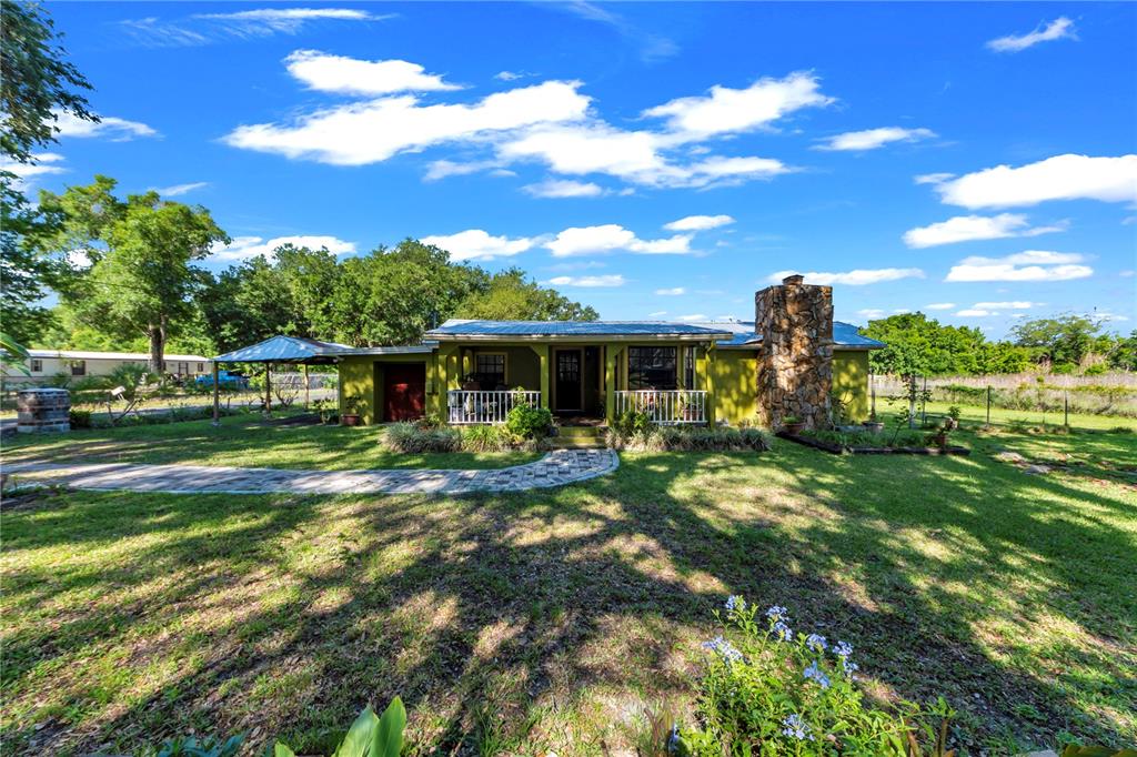 13610 Acker Road Dover, FL 33527 - Photo 33 of 53 a front view of a house with a garden