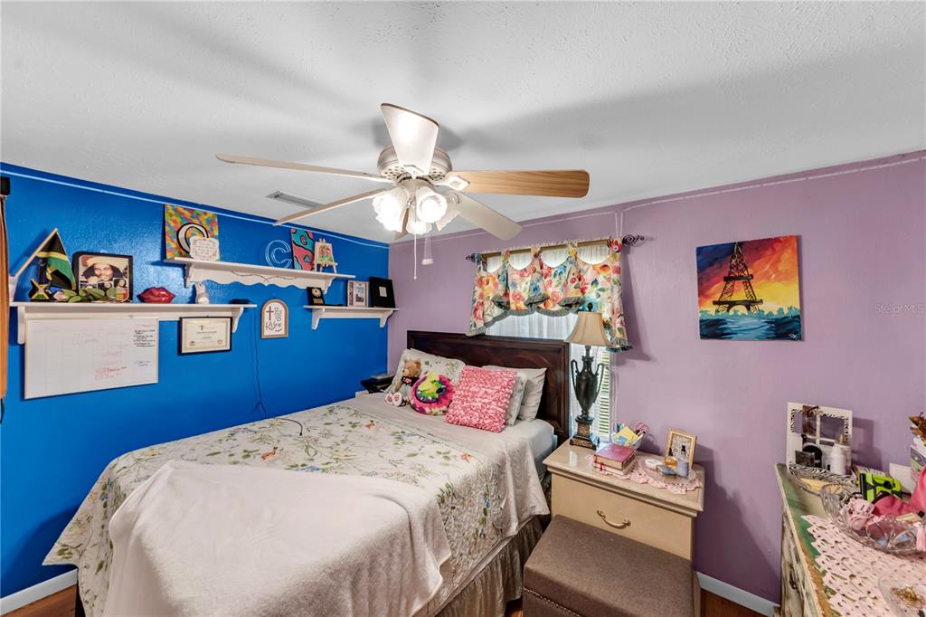 13610 Acker Road Dover, FL 33527 - Photo 38 of 53 a bedroom with a bed and wooden floor