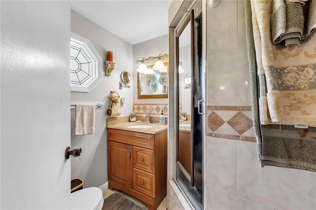 13610 Acker Road Dover, FL 33527 - Photo 48 of 53 a bathroom with a sink a mirror and a shower