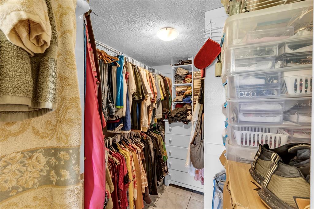 13610 Acker Road Dover, FL 33527 - Photo 49 of 53 a view of walk in closet with clothes and shoes