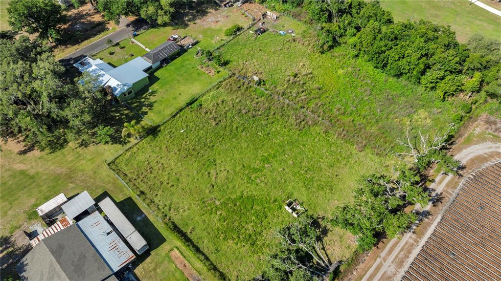 13610 Acker Road Dover, FL 33527 - Photo 5 of 53 an aerial view of a house with a yard and lake view