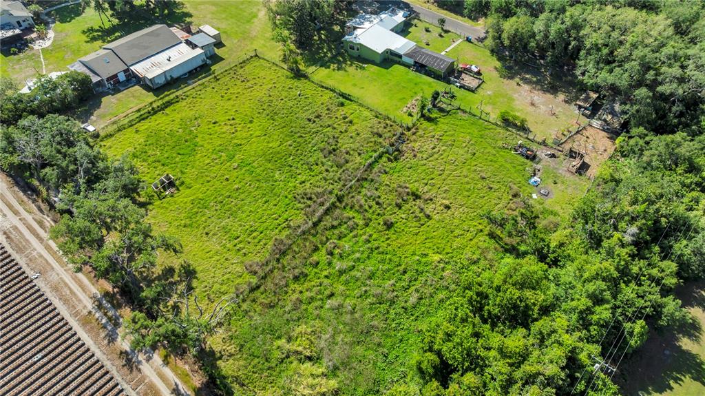 13610 Acker Road Dover, FL 33527 - Photo 7 of 53 an aerial view of residential house with swimming pool and lawn chairs