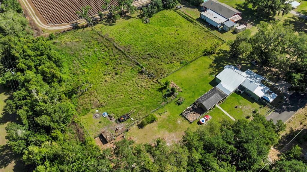 13610 Acker Road Dover, FL 33527 - Photo 9 of 53 an aerial view of a house with a garden and swimming pool