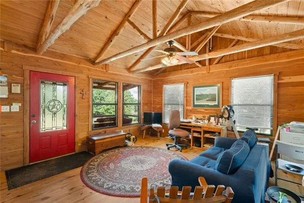 a living room with furniture rug and a table