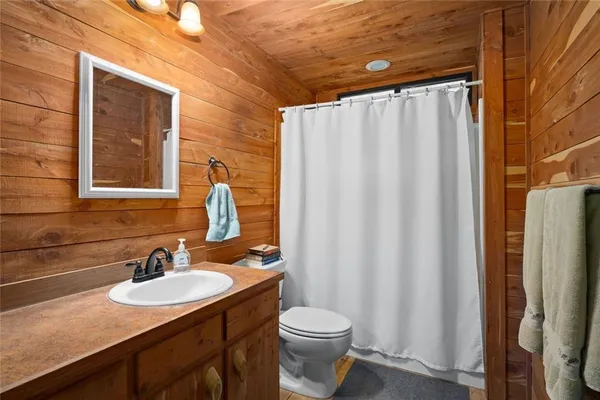 a bedroom with a bed and large windows