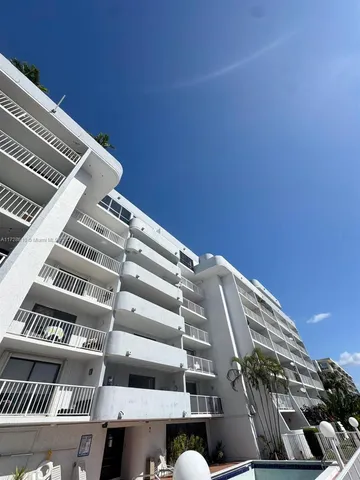 a view of a balcony with wooden floor and lake view