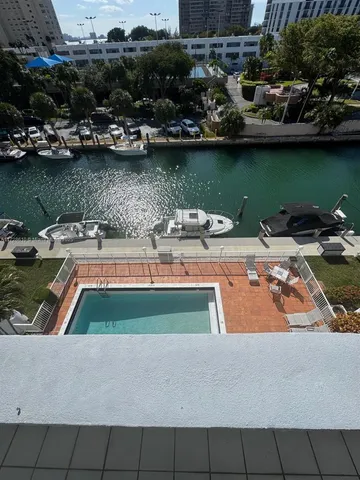 a view of a patio with chairs next to a yard