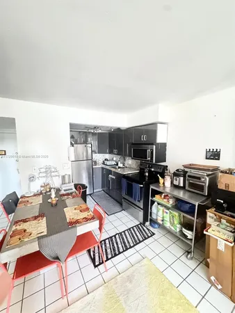 a kitchen with stainless steel appliances granite countertop a stove and a refrigerator