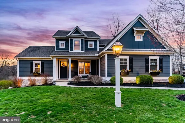a front view of a house with a yard and porch