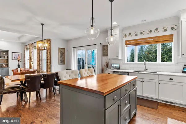 a kitchen with stainless steel appliances granite countertop a sink a stove and cabinets