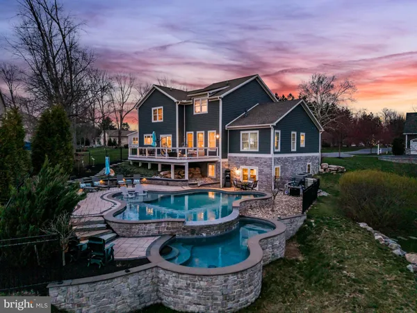 a dining room with furniture a chandelier and wooden floor