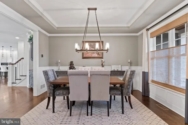 a living room with furniture a fireplace and a chandelier