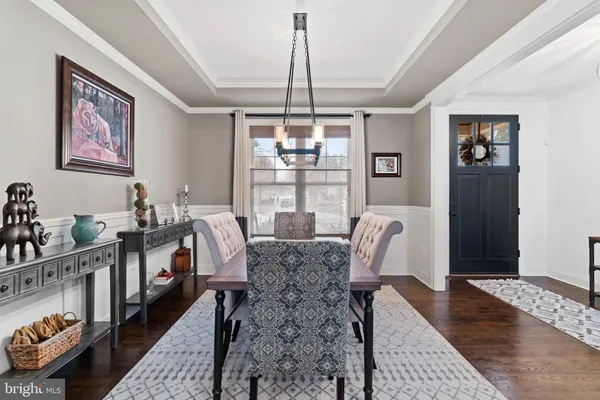 a living room with furniture a fireplace and a chandelier