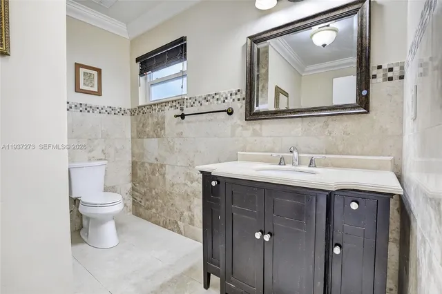 a bathroom with a toilet a sink a mirror and a shower