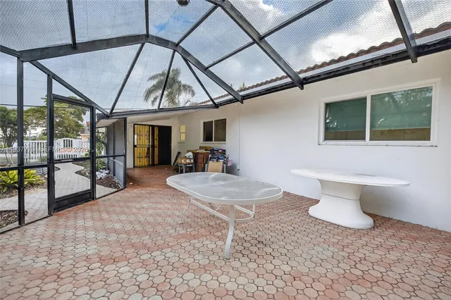 a view of a patio with table and chairs