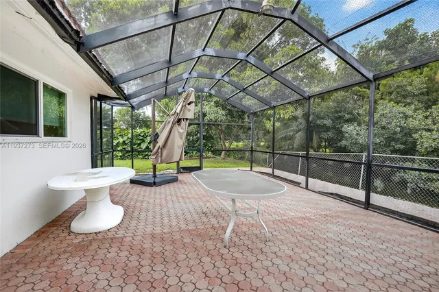 a view of a chairs and table in the patio