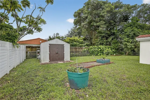 a view of a house with a backyard and a garden