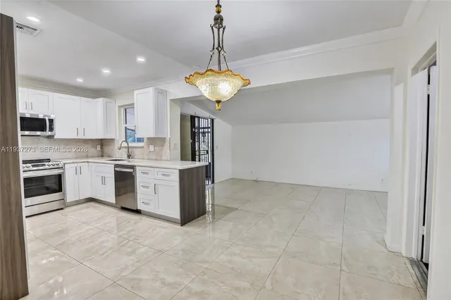 a kitchen with a stove a cabinets and window
