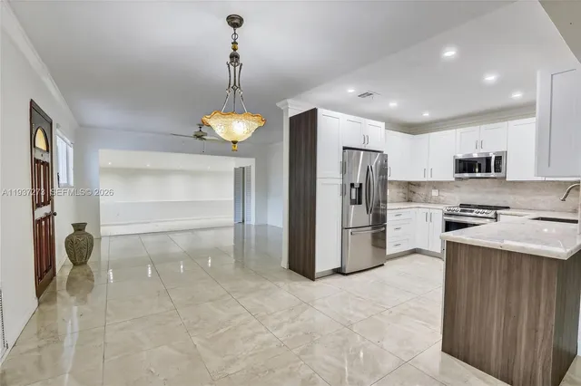 a kitchen with refrigerator and cabinets