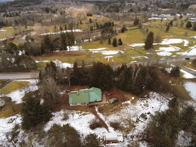 an aerial view of a house with a yard