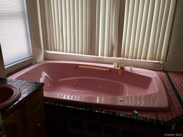 a bathroom with a shower and a sink