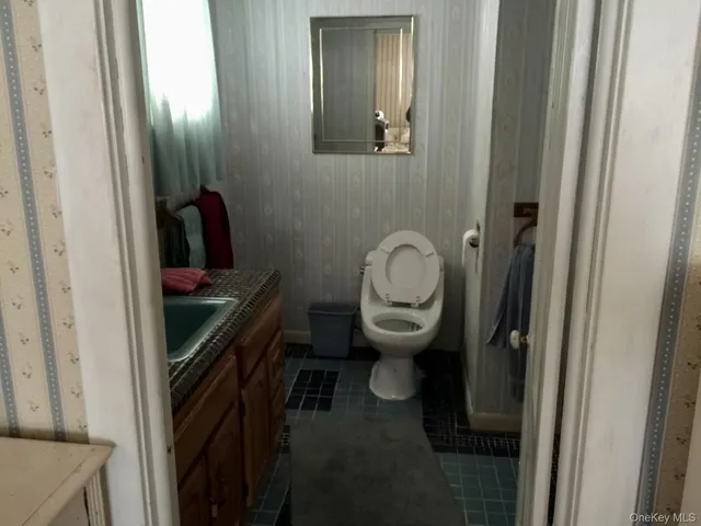 a kitchen with stainless steel appliances kitchen island granite countertop a refrigerator a stove a sink and dishwasher