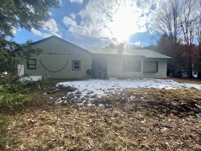 a view of a house with a trees in a yard