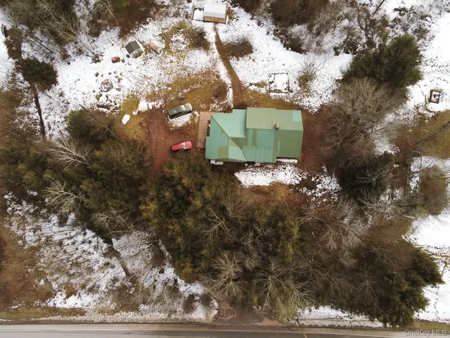 a backyard of a house with barbeque oven fire pit table and chairs