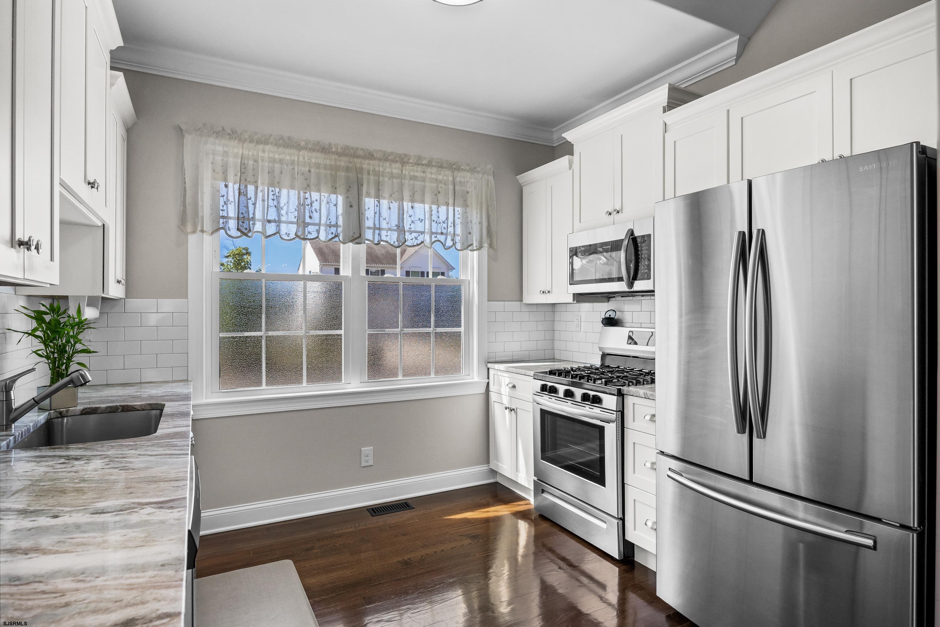 215 Surf Road Egg Harbor Township, NJ 08234 - Photo 10 of 31 a kitchen with stainless steel appliances a refrigerator and a window