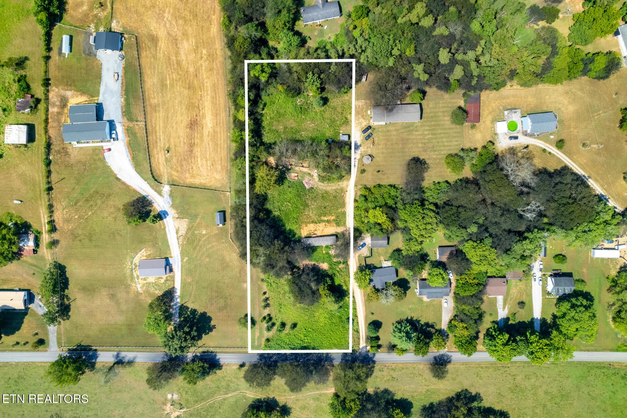 an aerial view of residential houses with outdoor space