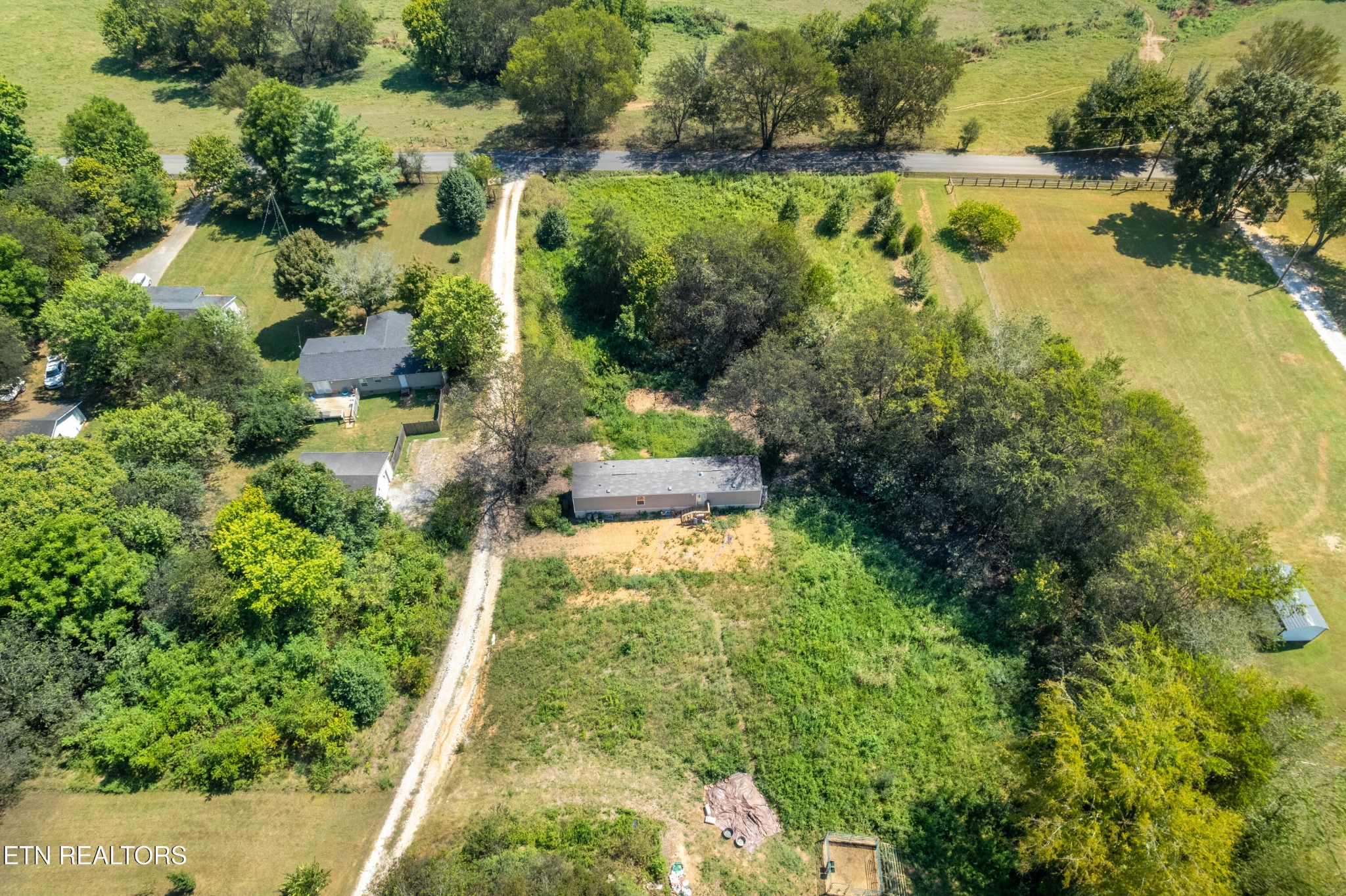 7109 Babelay Road Knoxville, TN 37924 - Photo 5 of 8 an aerial view of residential houses with outdoor space and trees all around