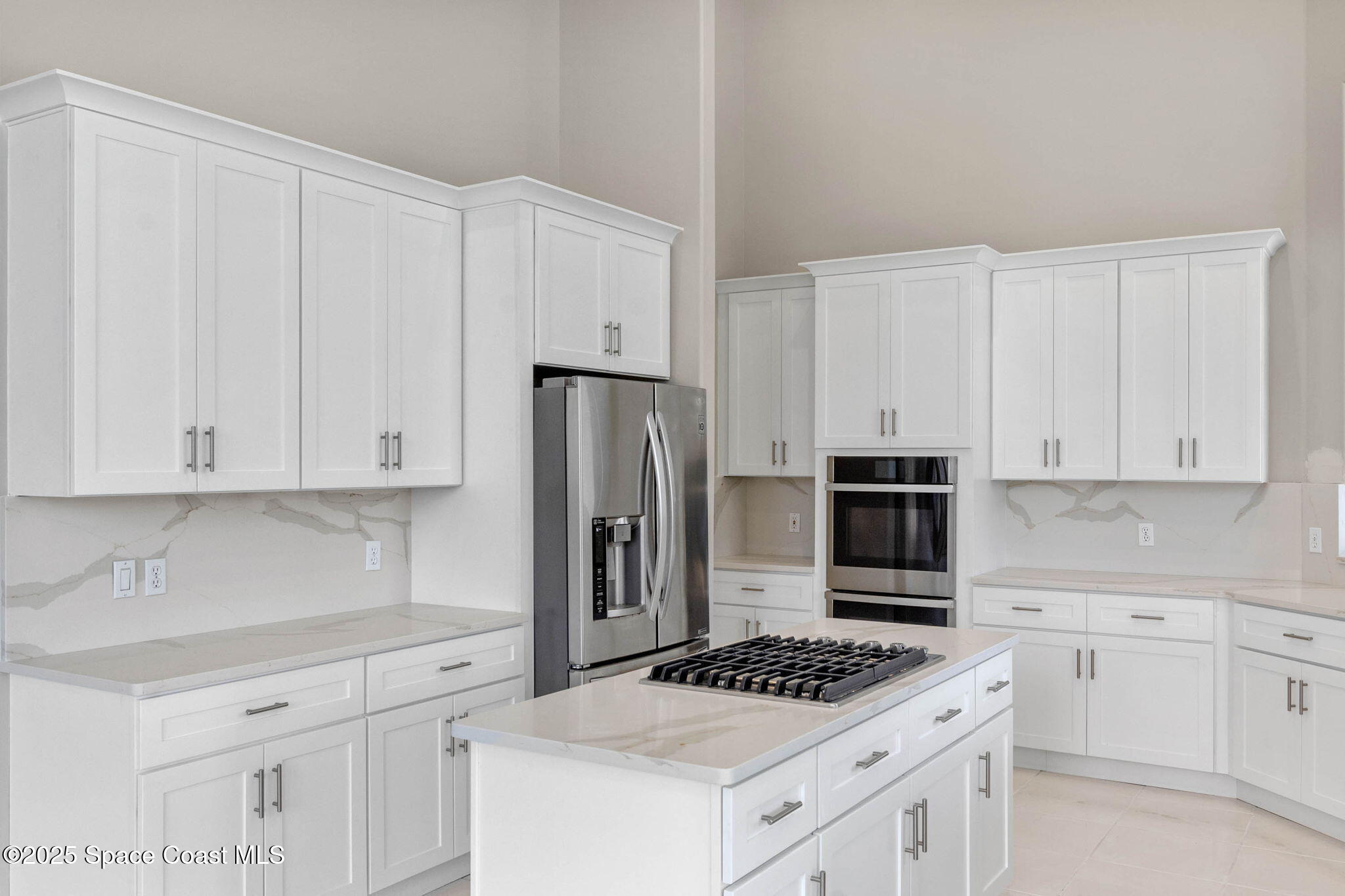 706 Palmer Way Melbourne, FL 32940 - Photo 12 of 43 a kitchen with white cabinets and appliances